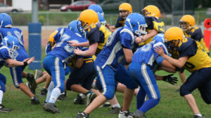 Young football players tackling