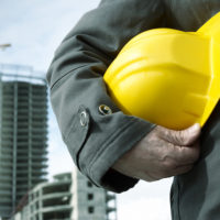Construction worker holding helmet