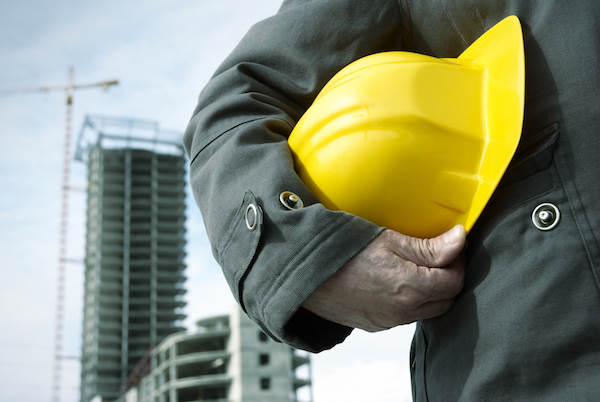 Construction worker holding helmet