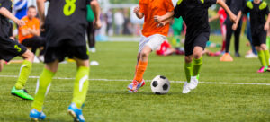 Two soccer players competing for ball