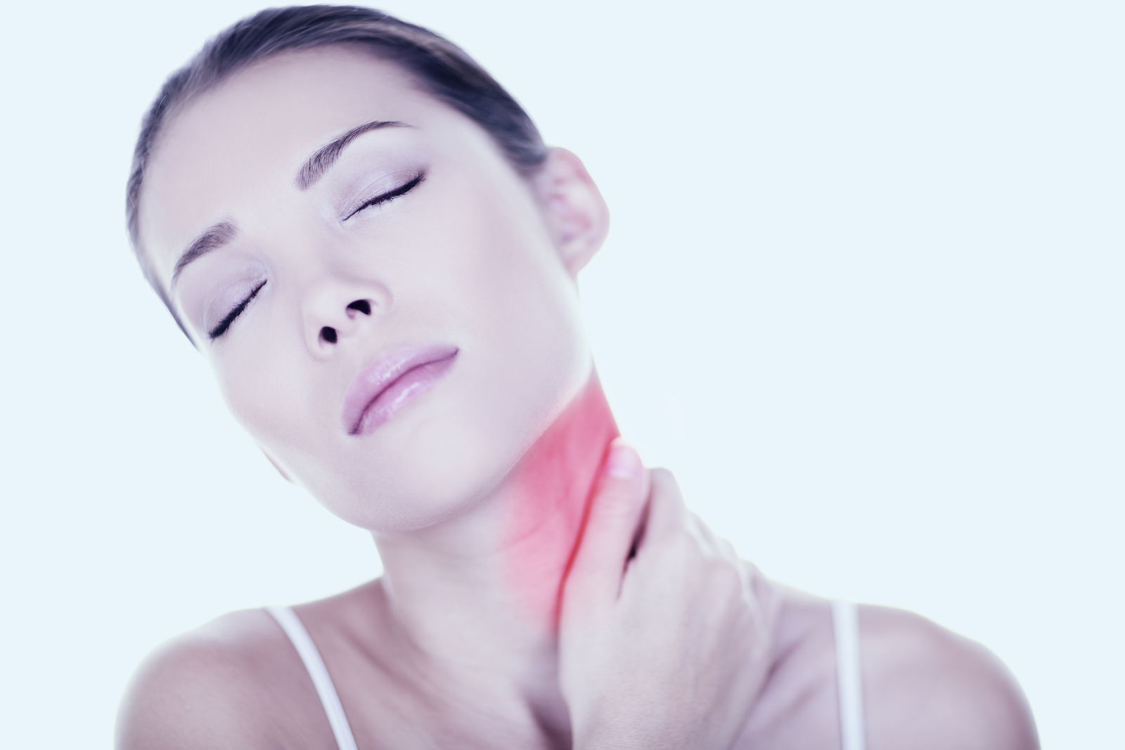 Woman with eyes closed holding neck in pain